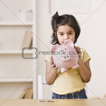Little Girl Holding a Piggy Bank