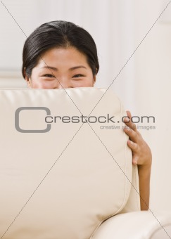 Woman Peeking Over Couch