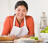 Asian woman making pie.