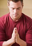 Attractive male in prayer