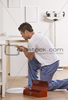 Attractive male with screwdriver.