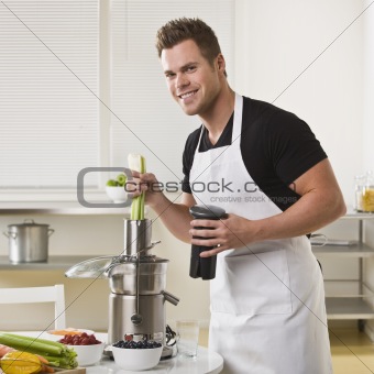 Attractive male with juicer.