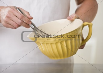 Man with whisk and bowl.