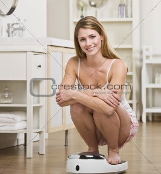 Woman Crouching on Scale