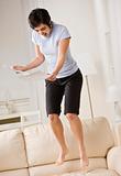 Excited Woman Jumping on Couch