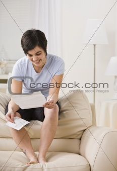 Attractive woman reading letter.
