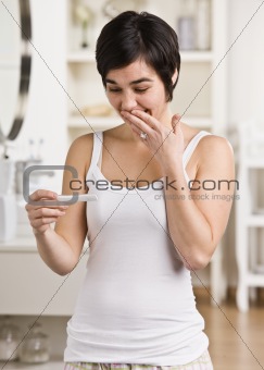 Woman looking at Pregnancy Test