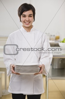 Woman Holding Stack of Dishes