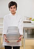 Woman with stack of dishes.