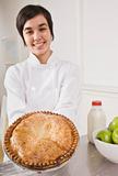 Attractive woman holding pie.