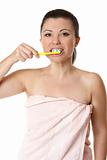 Female brushing her teeth with tooshpaste and toothbrush