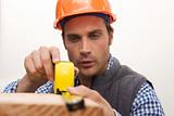 Laborer working with measuring tape