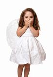 Little angel girl with hands covering her mouth