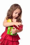 Girl holding an armful of Christmas presents