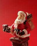 Santa Claus figurine over red background, studio