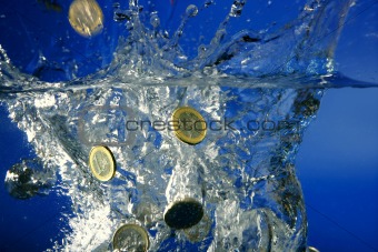 Euro coins fallin down to water