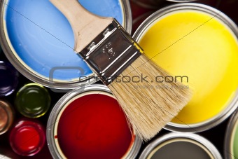 Cans and paint and brushes on the Colorful
