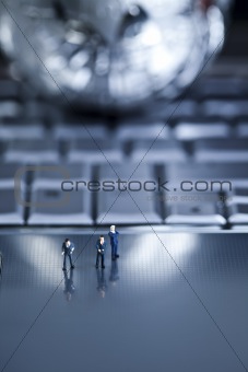 Laptop with figure over chrome background