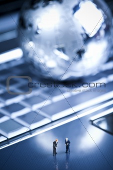 Laptop with figure over chrome background