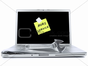 Laptop with sticky note and tool
