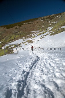 trekking alone on snow path