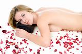 Woman lying on white covered in red flowers