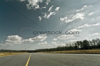 Empty highway, clouds and sky