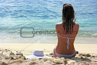 Brunette girl relaxing in water on the beach