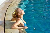 Blonde girl relaxing in hotel pool