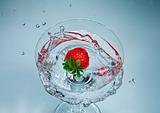 Splashing strawberry into a martini glass