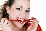 Beautiful young woman with a beads in a teeth