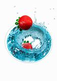 Splashing strawberry into a martini glass