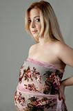side pose of young pregnant blonde woman