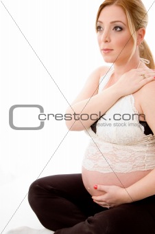 side pose of sitting pregnant female doing exercise