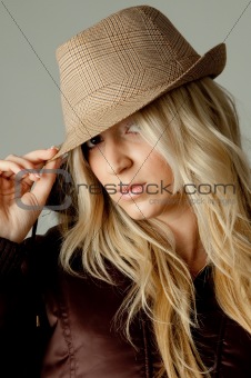portrait of young woman holding hat