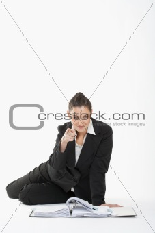 young beautiful businesswoman in suit pointing at the camera