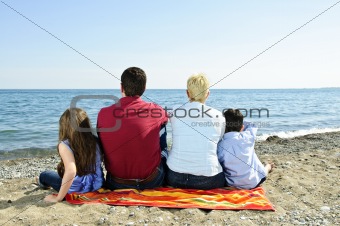 Family sitting at beach