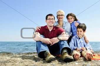 Happy family sitting at beach