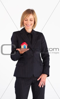 Frinedly mature businesswoman holding a house