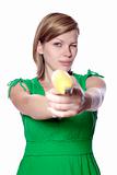 girl holds banana as a gun