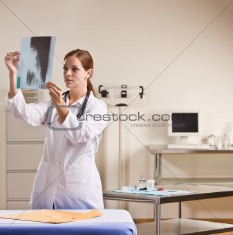 Doctor reviewing x-rays in doctorÕs office