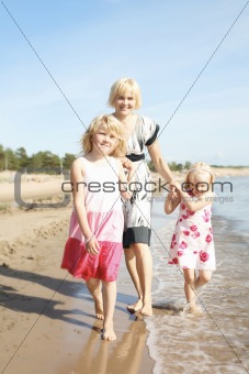 Mother and daughters at beach.