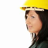 Young female architect or builder wearing a yellow hart hat