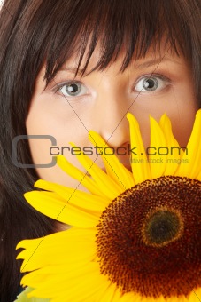 Young woman with a big sun flower