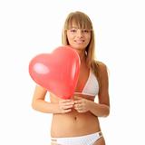 Woman in bikini with heart shaped baloon