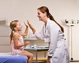 Doctor giving girl high-five