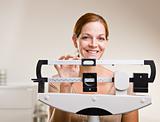 Woman weighing herself in doctorÕs office