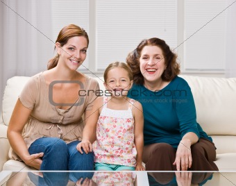 Three generation family sitting on sofa