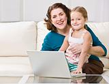 Grandmother and granddaughter using laptop