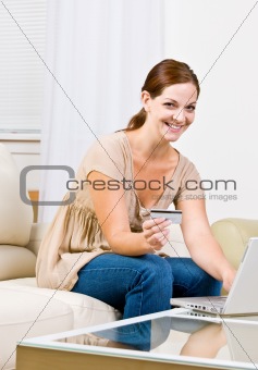 Woman using creditcard to buy internet merchandise